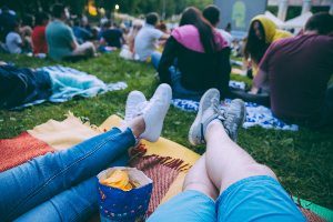 People sitting on blanket outside at a festival