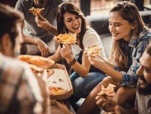 Young people enjoying pizza from the top 5 pizza places in Orlando
