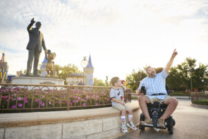 New Rides at Walt Disney World - Family standing by Partners statue and Cinderella's Castle at Magic Kingdom