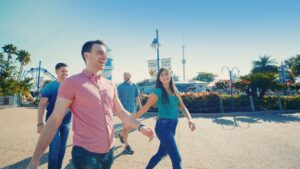 A group of friends passes through the SeaWorld Orlando parking lot on their way to the Seven Seas Food Festival