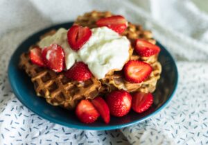 Waffles with strawberries and whipped cream