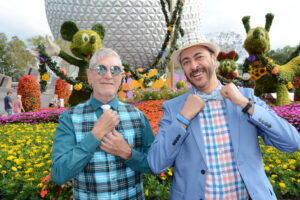 Two men in vintage outfits post outside Spaceship Earth in EPCOT for Dapper Day