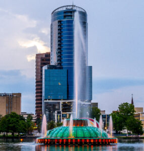 This beautiful Lake Eola with a colorful fountain and a big sky scraper is on the way to Paw Patrol Live from International Drive.