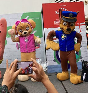 Skye and Chase of Paw Patrol posing for a fan's photo. 