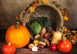 Thanksgiving cornucopia with a variety of vegetables in front of it