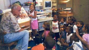Harris Rosen reading to children